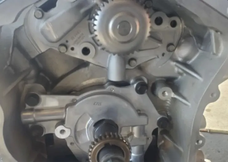 Close-up of the timing gears and front cover of a used engine at Villanueva Auto