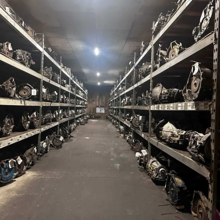 Aisle of used transmissions on steel shelving at Villanueva Auto’s Salinas warehouse